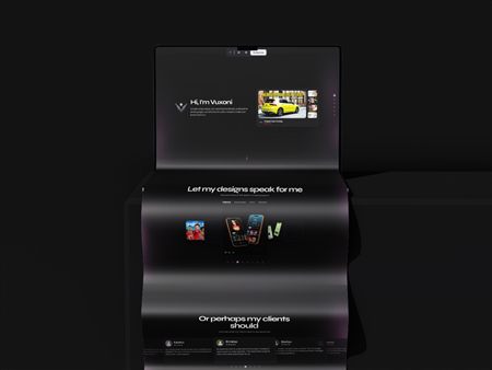 Vuxoni portfolio website presented on a folding laptop display